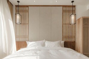 A bedroom with a bed, wooden headboard, and two pendant lights. - Shushan Lanting Boutique Hostel (Suzhou)