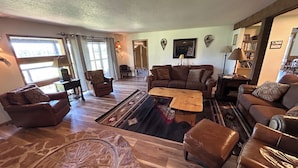 A spacious living room with leather sofas, a coffee table, and a patterned rug. - Exclusive Mountain Grandeur!
Back door to the Seven Devils Mountain range (Council)
