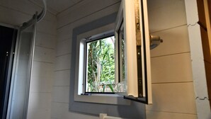 A room with a window, a door, and a ceiling with visible pipes. - Chalet with private spa, garden, all within walking distance. (Saint-Rémy-de-Provence)
