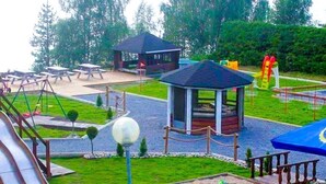 A playground with a slide, swings, and a gazebo. - ArcticMagic (Tervola)