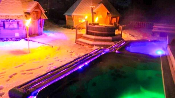 A snow-covered outdoor area with a hot tub and wooden structures. - ArcticMagic (Tervola)
