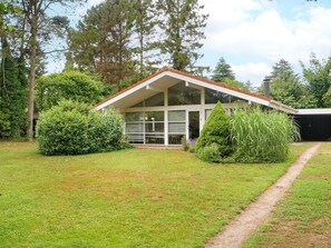 A modern house with a sloped roof, large windows, and a well-maintained lawn. - 8 Person Holiday Home in Gilleleje (Gilleleje)