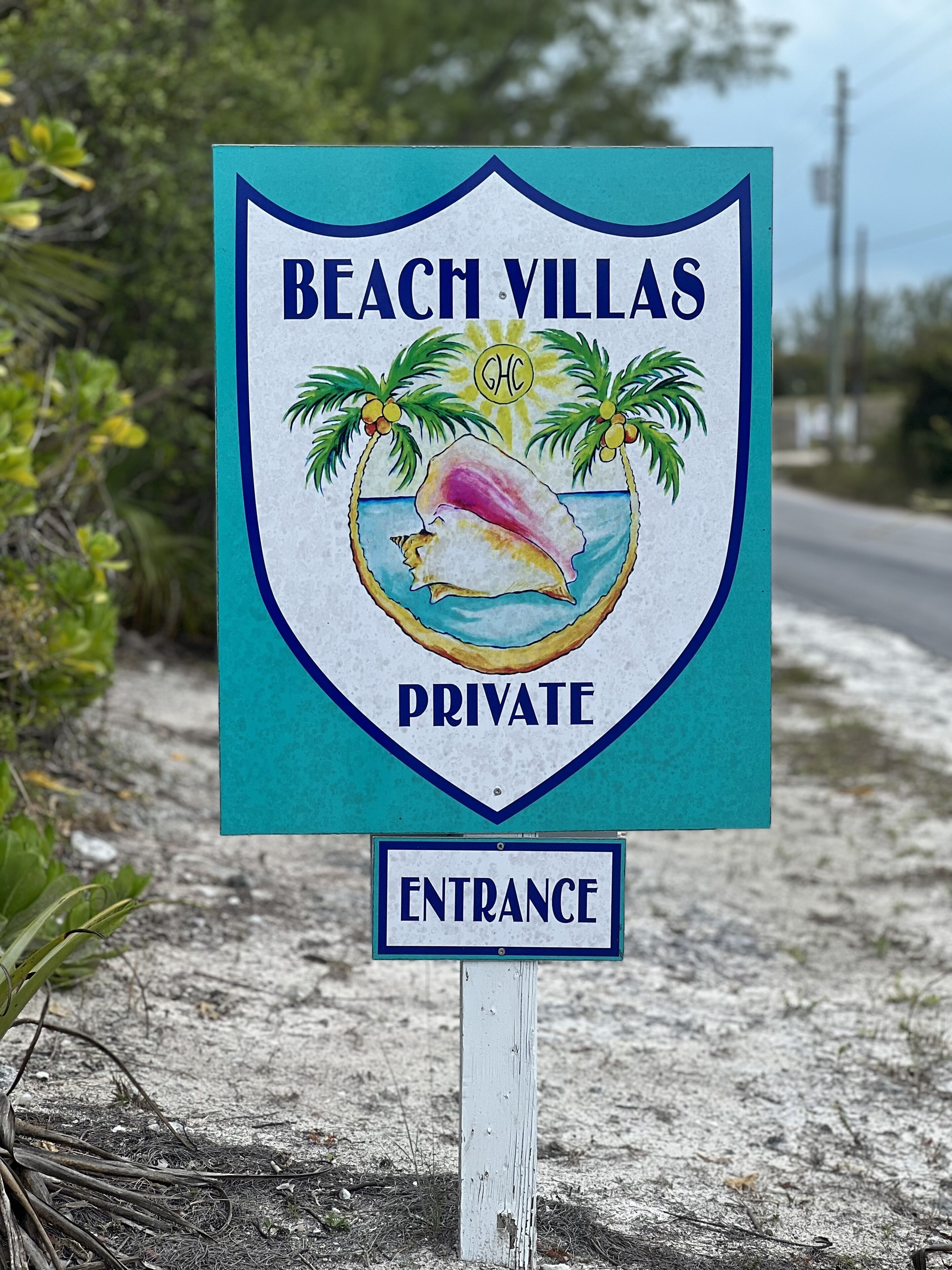 A sign for Beach Villas Private, indicating an entrance to a private property.