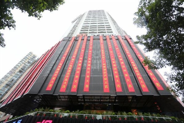A tall building with vertical red text on its facade.