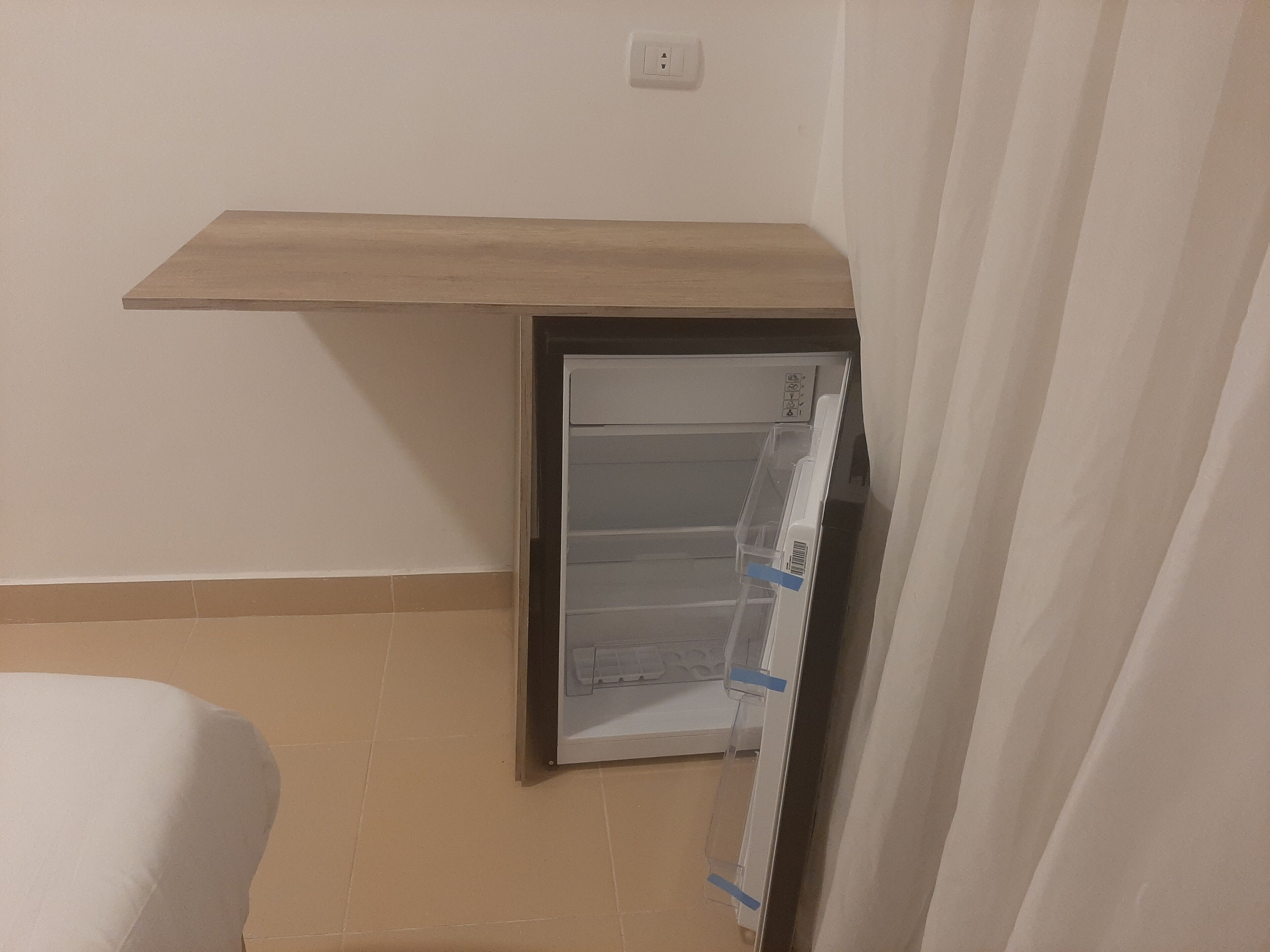 A bathroom with a toilet, a shower, and a sink.