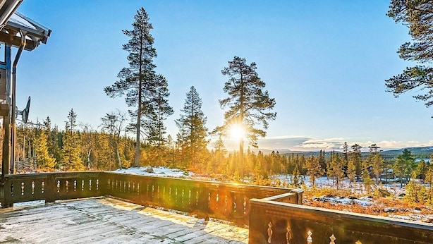 A wooden deck with a railing overlooking a snowy landscape with trees and mountains in the distance. - 4 Star Holiday Home in Veggli (Rollag)