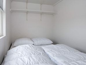 A single-bed room with a white bedspread and pillows, a window with blinds, and a white ceiling with a light fixture. - 5 Person Holiday Home in Ansager (Ansager)