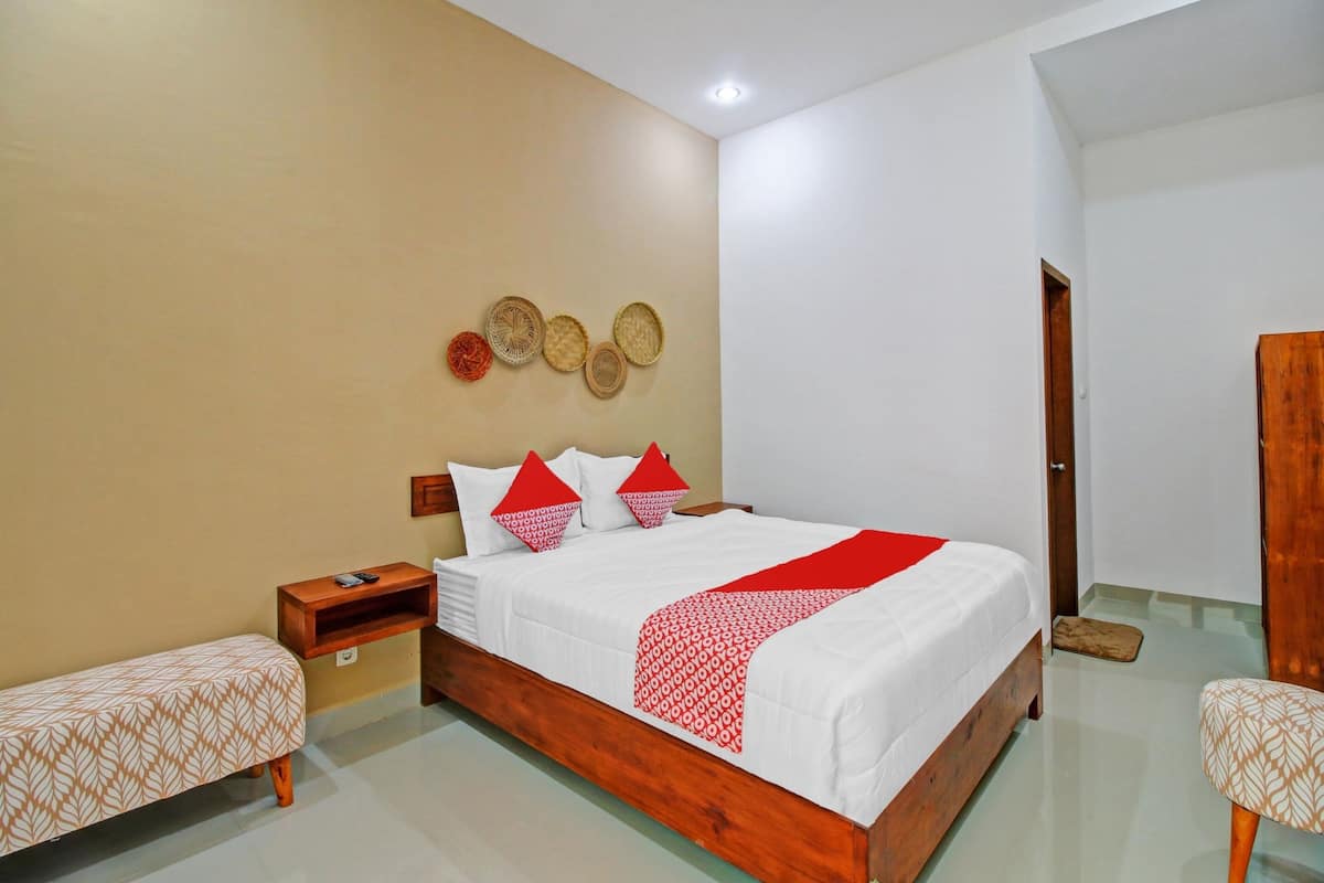A neatly arranged bedroom with a wooden bed, a bedside table, and a bench.