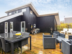A modern outdoor deck with a dining area and seating. - 4 Person Holiday Home in Hemmet (Hemmet)