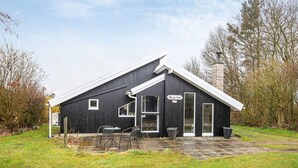 A black building with a white roof, a sign reading 'Dammtor,' and two tables outside. - 4 Person Holiday Home in Hemmet (Hemmet)