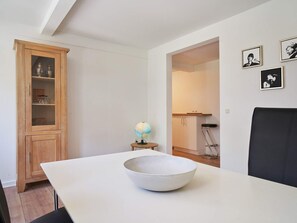 Simple, functional space with a wooden cabinet, globe, and comfortable seating area.
