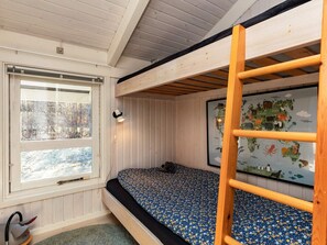 A bunk bed room with a window, a map on the wall, and a ladder.