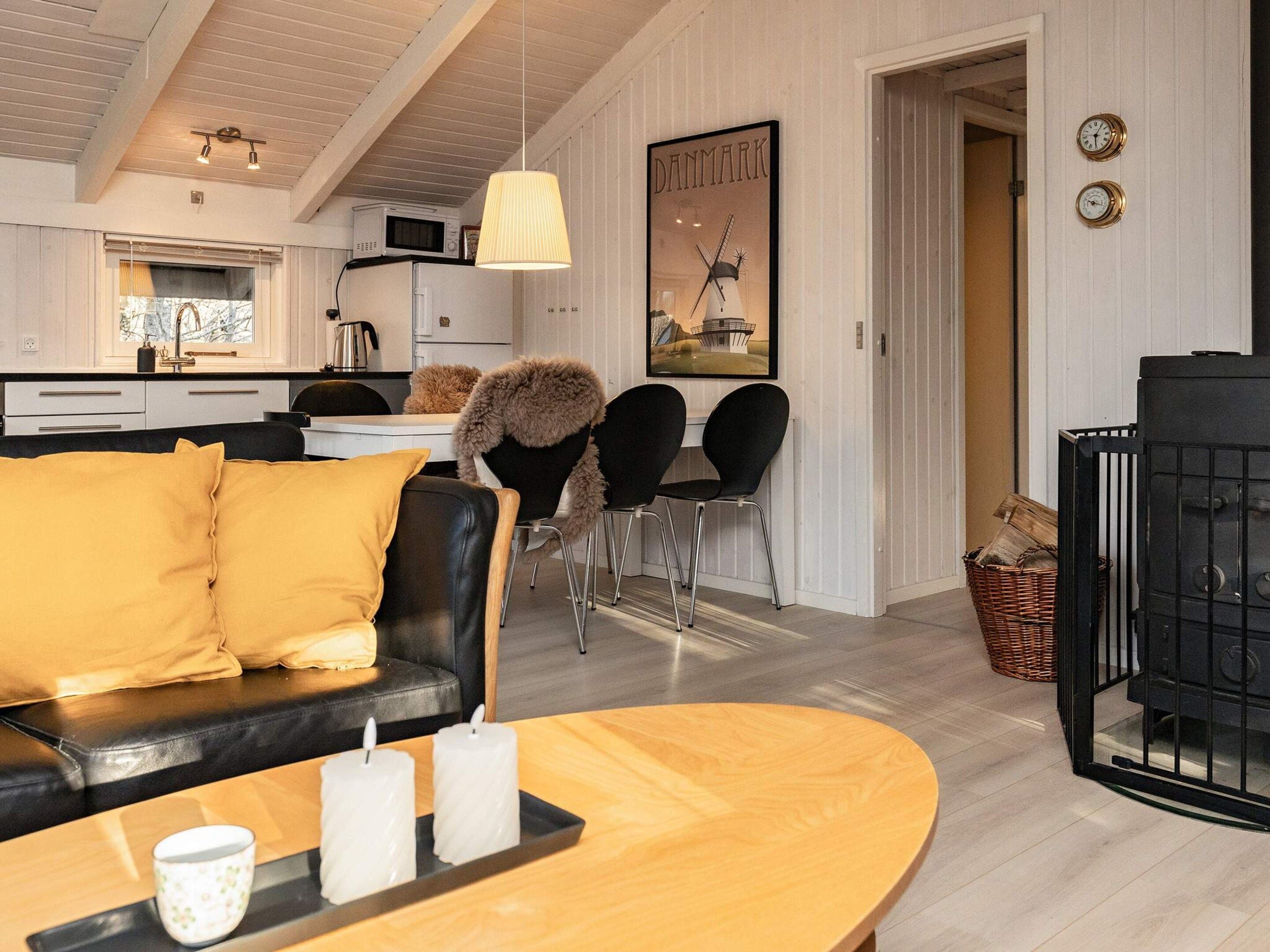 A modern living room with a sofa, a coffee table, and a fireplace.