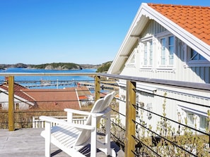 A white building with a red-tiled roof overlooking a marina. - 4 Star Holiday Home in Tanumshede (Tanum)