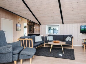 A modern living room with a sofa set, a coffee table, and a television. - 7 Person Holiday Home in Hejls (Hejls)