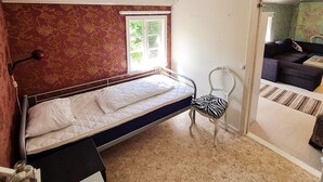 A bedroom with a single bed, a chair, and a window. - 5 Person Holiday Home in Haltorp (Halltorp)