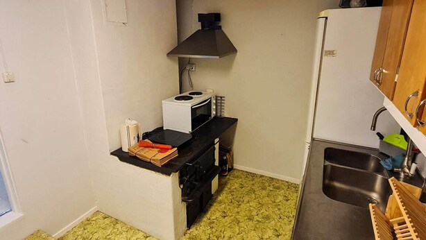A compact kitchen with a stove, microwave, and sink. - 5 Person Holiday Home in Haltorp (Halltorp)