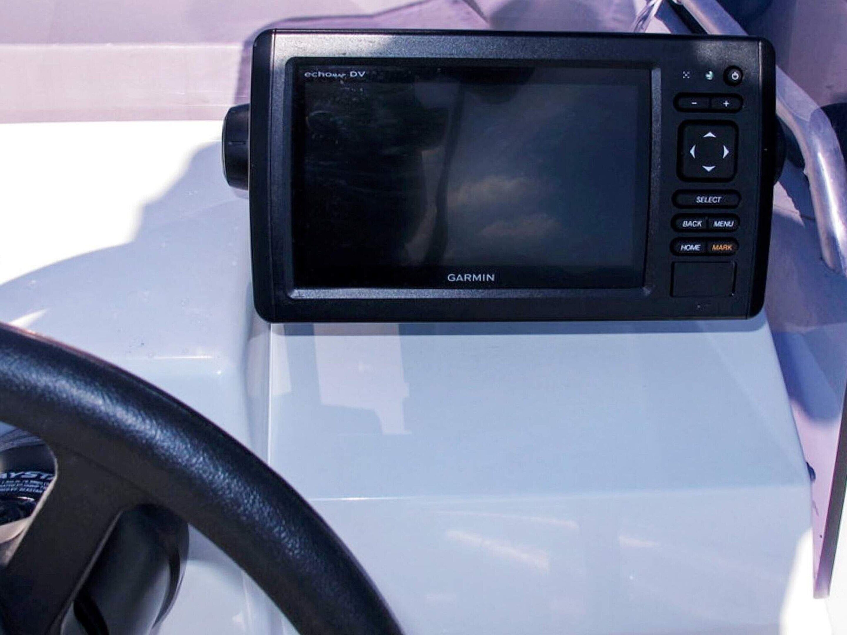A Garmin GPS device mounted on a vehicle's dashboard.