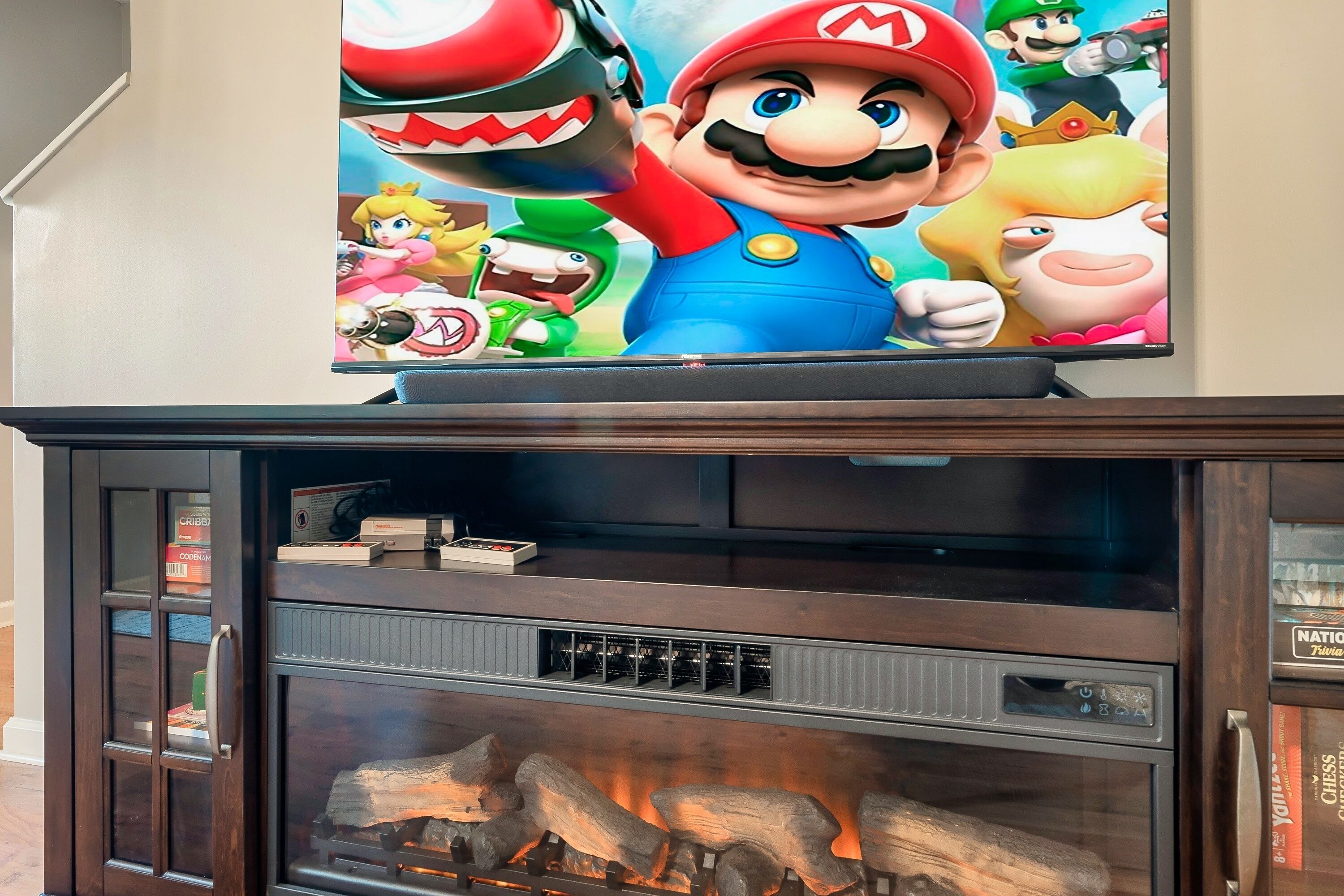 A fireplace with a Mario-themed wall decal above it.