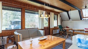 A cozy cabin interior with a wooden table, a sofa, and a dining area. - 6 Person Holiday Home in Hals-by Traum (Hals)