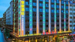 A multi-story hotel with illuminated signage and a prominent entrance.