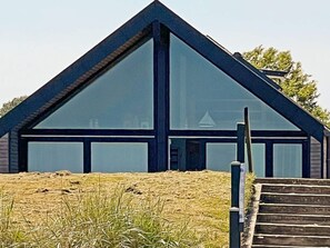 A modern building with a triangular roof and large windows. - 6 Person Holiday Home in Otterup (Otterup)