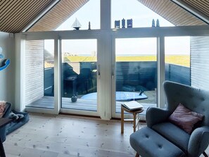 A room with a large sliding glass door leading to an outdoor deck. - 6 Person Holiday Home in Otterup (Otterup)