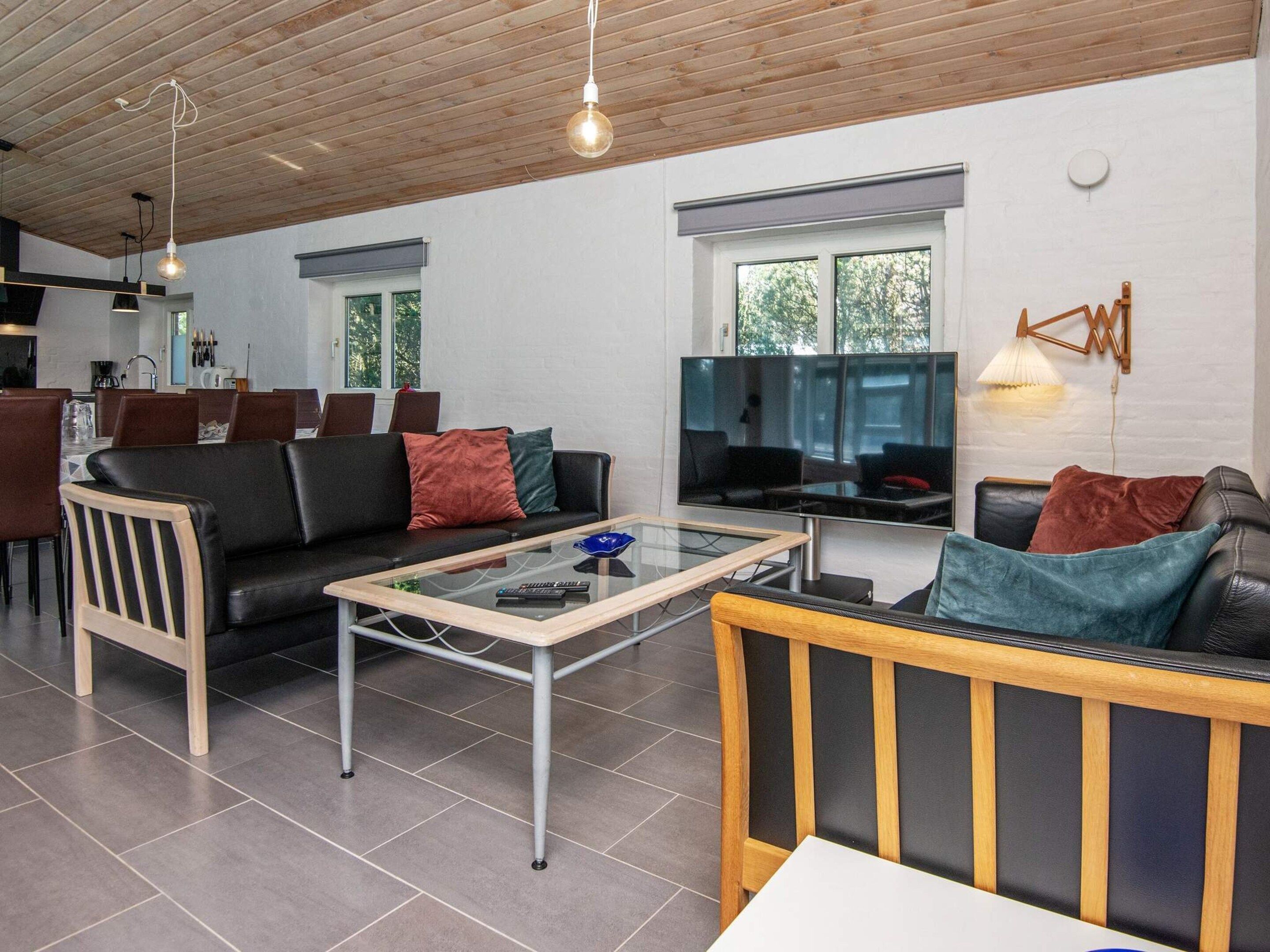 A modern living room with a sofa, coffee table, and a television.
