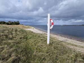 A lifebuoy attached to a pole by the lakeside. - 6 Person Holiday Home in Hojslev (Hojslev)