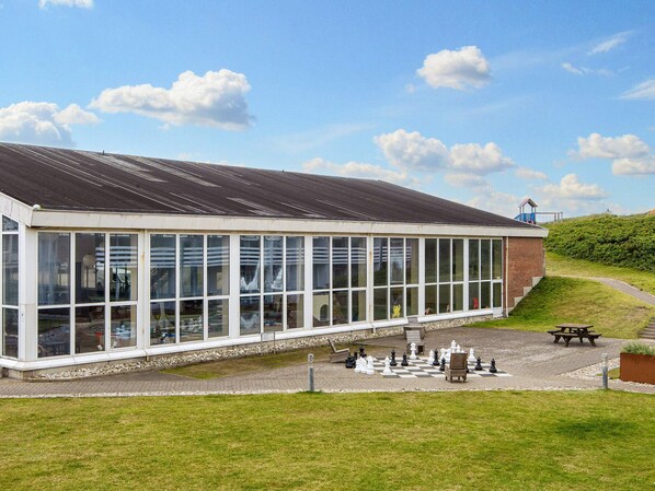 A building with large windows and a covered outdoor area.