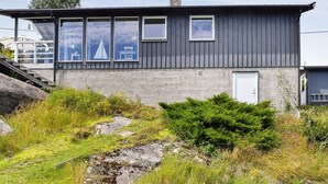 A modern two-story house with a grey exterior, large windows, and a white door. - 8 Person Holiday Home in Filtvet (Asker)