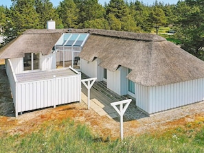 A modern house with a thatched roof, a large window, and a white exterior. - 8 Person Holiday Home in Fjerritslev (Fjerritslev)