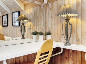 A wooden interior with a white table, two lamps, and three potted plants. - 8 Person Holiday Home in Fjerritslev (Fjerritslev)