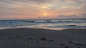 A beach with a sunset over the ocean. - 6 Person Holiday Home in Saltum (Saltum)