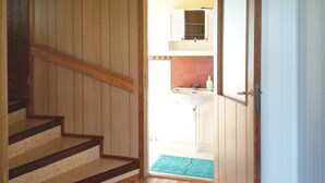 A wooden staircase leading to a bathroom with a sink and a window. - 5 Person Holiday Home in Lulea-by Traum (Luleå)