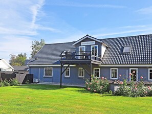 A two-story building with a balcony and a sign reading 'Strandgaarden'. - 6 Person Holiday Home in Hadsund (Hadsund)