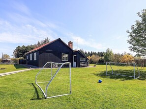 A house with a fenced yard, a soccer goal, and a blue ball. - 6 Person Holiday Home in Vinderup (Vinderup)