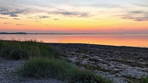A beach with a view of the water and distant land. - 6 Person Holiday Home in Farso (Farso)