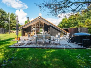 A modern house with a large deck, outdoor seating, and a hot tub. - 4 Star Holiday Home in Ulfborg (Ulfborg)