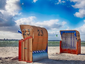 Two beach huts with numbers 23 and 24, a sandy beach, and the sea in the background. - 5 Star Holiday Home in Wendtorf (Wendtorf)