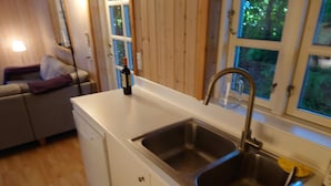 A compact kitchen with a sink, a countertop, and a window. - 5 Person Holiday Home in Dronningmolle (Dronningmolle)