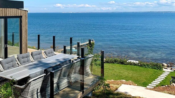 A modern outdoor seating area with a view of the sea. - Stylish Seaside Villa on Ven-by Traum (Sankt Ibb)