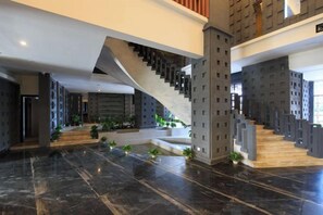 A modern interior with a staircase, marble flooring, and a large open space. - Chengshi Daren Garden Hotel (Laibin)