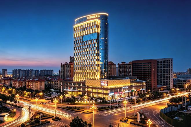 A high-rise hotel with a modern design, surrounded by a well-lit urban area.