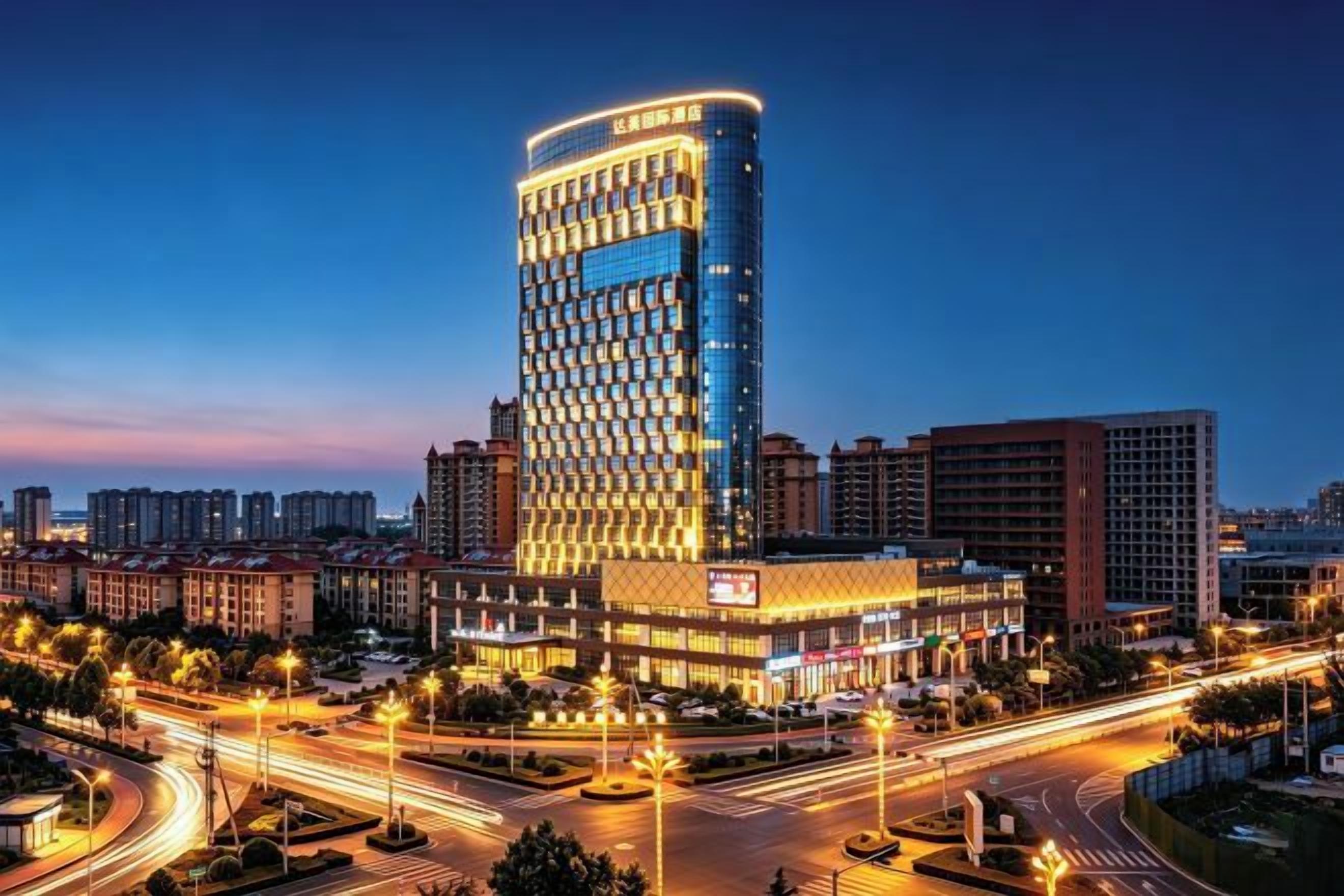A high-rise hotel with a modern design, featuring a prominent curved facade and illuminated signage.