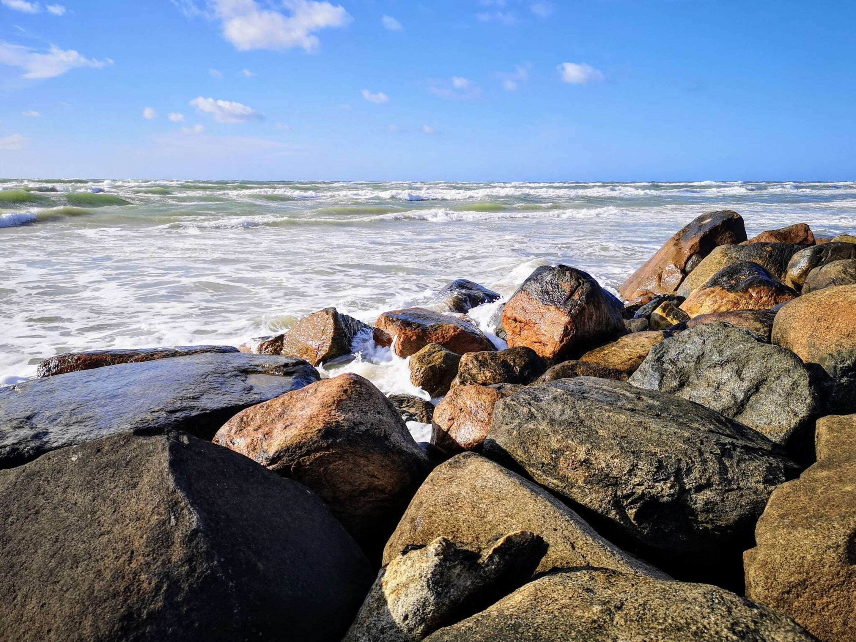 A rocky shoreline with waves crashing against the rocks.