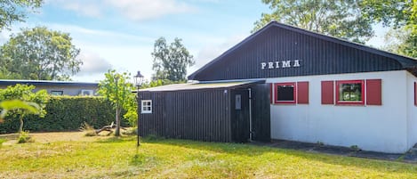 A building with a sign reading 'PRIMA' and a small adjacent structure.