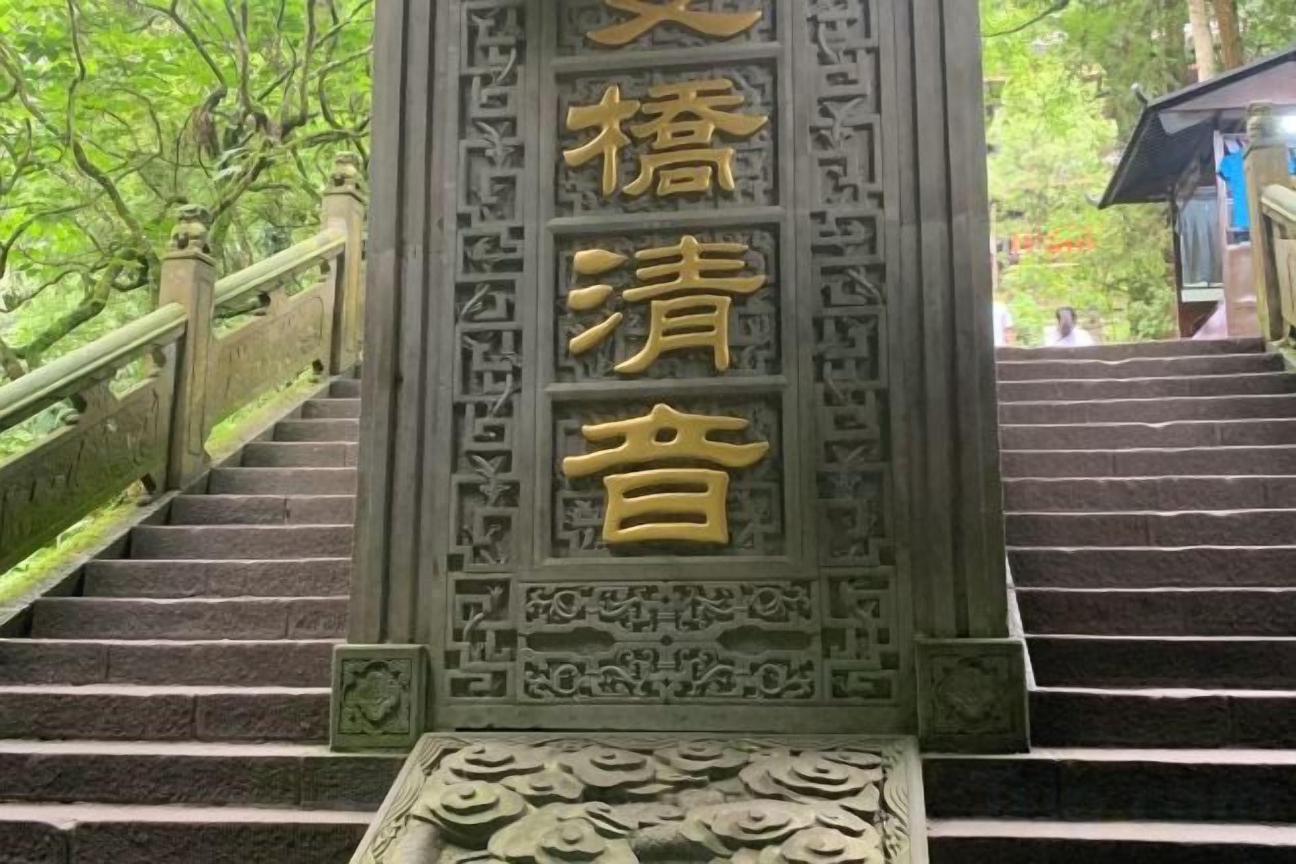 A staircase with ornate metal railings and a decorative stone balustrade.