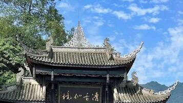 A traditional Chinese architectural structure with ornate roof details and a signboard.