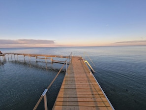 A wooden pier extending into calm water with a clear sky above. - 6 Person Holiday Home in Vaeggerlose (Vaeggerlose)